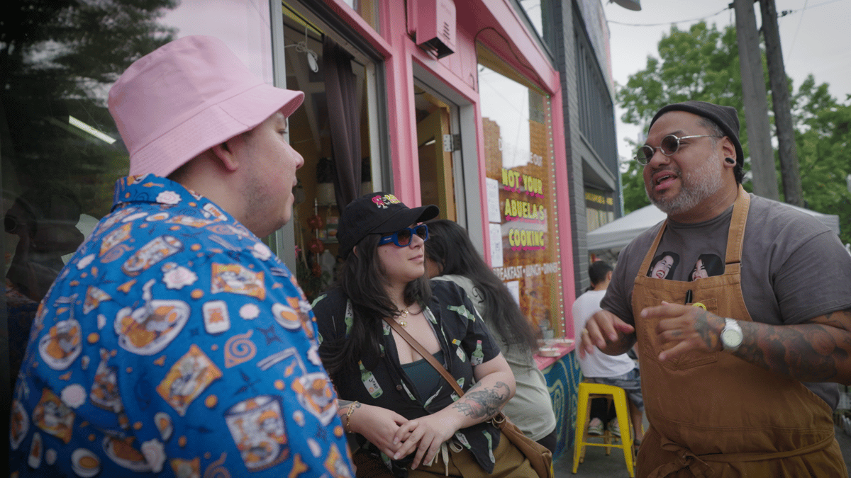 Chef José Garzon speaks to customers outside his restaurant, Bad Chancia, in Seatle