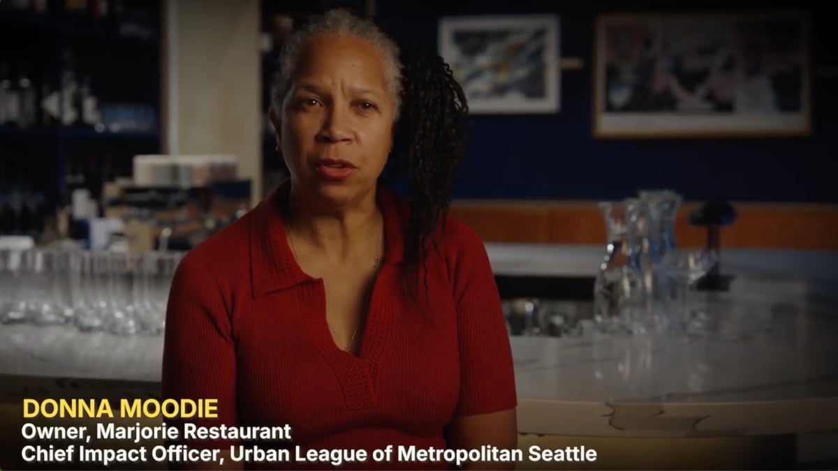 Screen Capture of Donna Moodie from the Kitchen Currents Video. Donna is in her restaurant, Majorie, describing how they electrified it. Her titles, Owner, Majorie Restaurant and Chief Impact Officer, Urban League of Metropolitan Seattle are listed at the bottom.